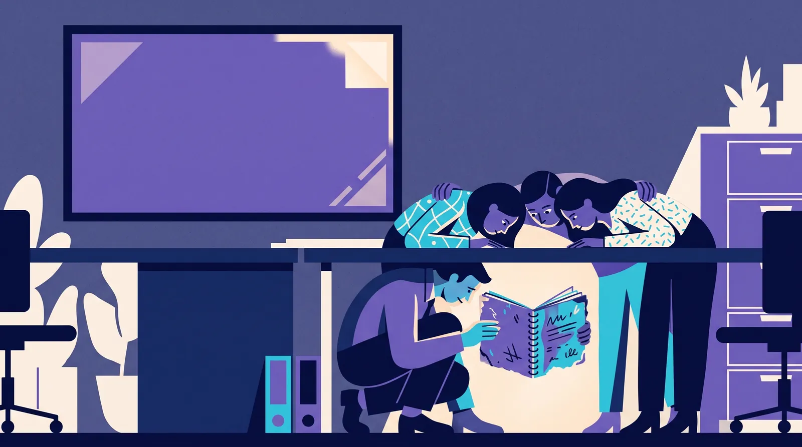 Colleagues huddle around a battered notebook under a desk while the large screen on the wall stays blank
