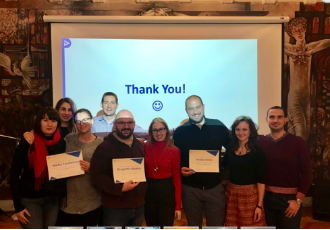 Group of training participants holding their certificates